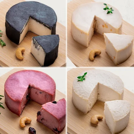 Um kit com todos os nossos Queijos de Corte de Castanha de Caju! O kit contém 4 Queijos de Castanha de Caju: 1 Queijo de Castanha de Caju Defumado, 1 Queijo de Castanha de Caju Trufado com Damasco, 1 Queijo de Castanha de Caju com Cranberry, 1 Queijo de Castanha de Caju com Gergelim. Os queijos são fotografados lateralmente.